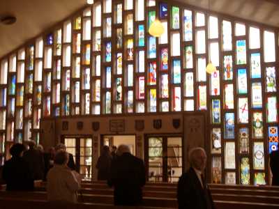 The inside of St Georges Church, Halton showing the stained glass window. A colourful stained glass window showing Apprentice Entry windows.