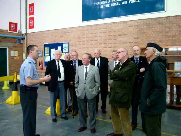 Group of men standing in an office.