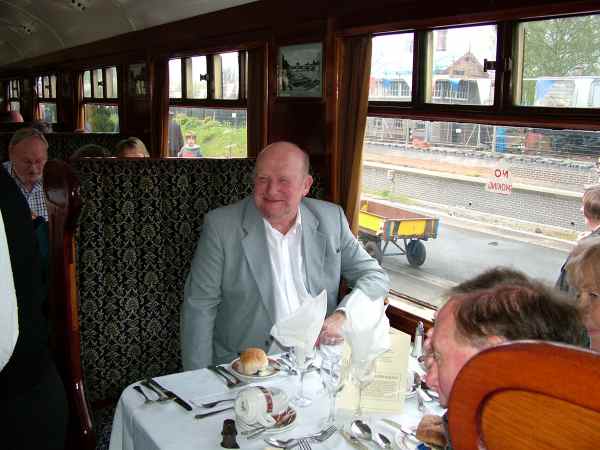man  sitting in a railway carriage.