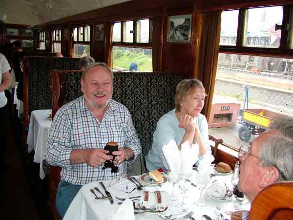 man and woman sitting in a railway carriage.