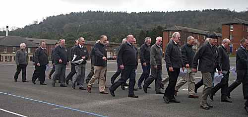 A group of seventy year olds marching on a parade ground