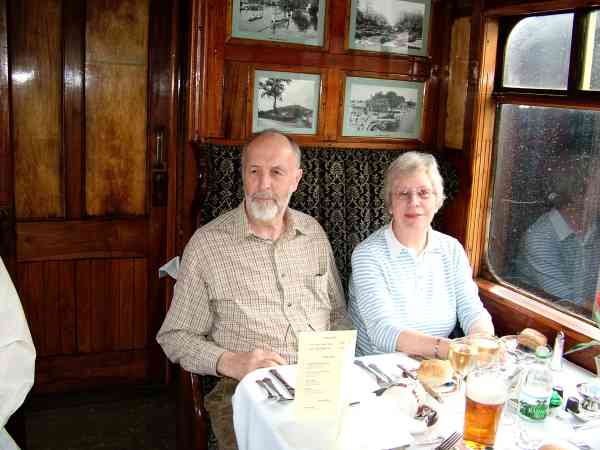 man and woman sitting in a railway carriage.