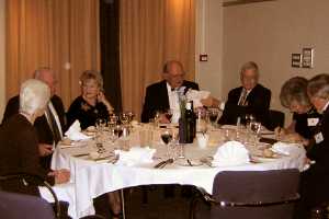 The Celebration Dinner. Diners sitting and talking around a dining table.