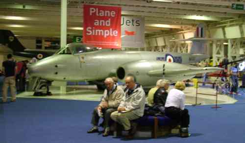 Relaxing at Hendon Aircraft Museum. A group of people sitting on a bench.